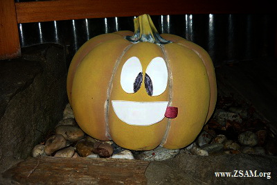 Pumpkin with big smile, squinting eyes, protruding tongue